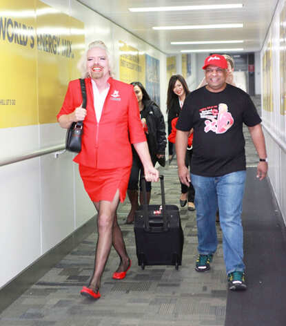 Richard Branson dresses up as AirAsia flight attendant