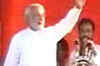 Modi attempts to shed 'communal' tag